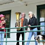 Kristin Smith, Mike McLeron and Gwen Franz, posing with her dog Hugo, are among the teachers who will host a pay-what-you-can music camp outdoors at Fort Worden State Park this summer. The first session starts June 28. Signup is available at YEAmusic.org. (Diane Urbani de la Paz/Peninsula Daily News)
