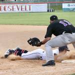 Wilder Senior's Michael Grubb dives safely back to the first-base bag on a pickoff attempt as Seattle Select's Alex Ballot prepares to apply the tag during an American Legion game Monday at Civic Field. (Dave Logan/for Peninsula Daily News)