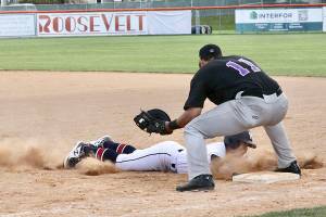 Wilder Senior's Michael Grubb dives safely back to the first-base bag on a pickoff attempt as Seattle Select's Alex Ballot prepares to apply the tag during an American Legion game Monday at Civic Field. (Dave Logan/for Peninsula Daily News)