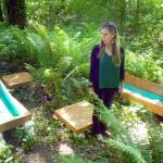 Port Angeles Fine Arts Center executive director Christine Loewe admires an art installation, The Pool Zone by Chris Oliver, debuting Saturday in the Websters Woods Sculpture Park. (Keith Thorpe/Peninsula Daily News)
