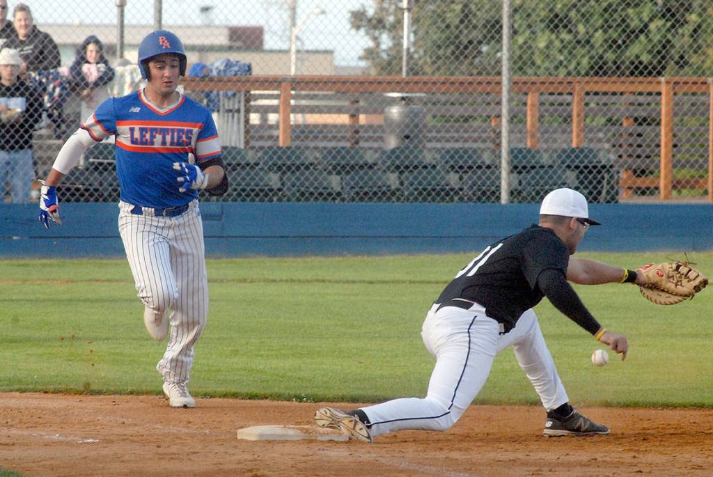 Keith Thorpe/Peninsula Daily News Lefties Ricardo Amavizca makes it safely to first as Driveline first baseman Luis Mendendez bobbles the ball in the third inning on Friday at Port Angeles Civic Field.