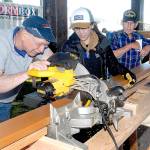 Volunteers, from left, John Albiso, Tien Vo and Bill Chastain cut boards that will become part of the Generation II Dream Playground during the first day of a six-day community build on Tuesday at Erickson Playfield in Port Angeles. The playground will replace an antiquated version that was built by volunteers in 2002 and torn down earlier this year. Organizers are still seeking volunteers to help with construction, the loan of woodworking tools and monetary donations. More information on the build is at www.padreamplayground.org. (Keith Thorpe/Peninsula Daily News)