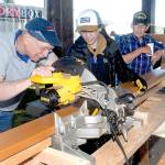 Volunteers, from left, John Albiso, Tien Vo and Bill Chastain cut boards that will become part of the Generation II Dream Playground during the first day of a six-day community build on Tuesday at Erickson Playfield in Port Angeles. The playground will replace an antiquated version that was built by volunteers in 2002 and torn down earlier this year. Organizers are still seeking volunteers to help with construction, the loan of woodworking tools and monetary donations. More information on the build is at www.padreamplayground.org. (Keith Thorpe/Peninsula Daily News)