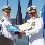 Commander Donald Emmerson, left, receives the Meritorious Service Medal from Rear Admiral Brad Collins, commander of Navy Region Northwest, during Naval Magazine Indian Islands Change of Command ceremony on Thursday. Emmersons role of commanding officer is now filled by Commander Andrew Crouse. (Zach Jablonski/Peninsula Daily News)