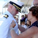 Commander Andrew Crouse assumed command of Naval Magazine Indian Island on Thursday. During the ceremony, his parents, Diane and George, pinned on the Navys Command Ashore pin that he received during the Change of Command. (Zach Jablonski/Peninsula Daily News)