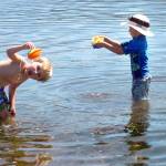Xander Sivo, 6, left, and Matthew Taber, 4, both of Port Angeles, play in the water of Port Angeles Harbor at Ediz Hook in Port Angeles on Saturday, With temperatures creeping into the 90s across much of the North Olympic Peninsula, many people are seeking relief from the heat, which is expected to last at least through Monday. (Keith Thorpe/Peninsula Daily News)