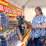 Paula Walters of Port Angeles looks over a selection of fireworks on display on Tuesday at a fireworks tent operated by the Clallam County Amateur Radio Club at the Safeway shopping plaza on U.S. Highway 101 east of Port Angeles. (Keith Thorpe/Peninsula Daily News)