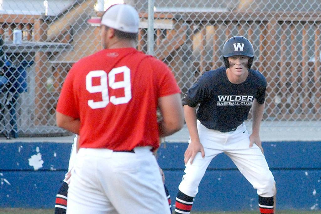 Keith Thorpe/Peninsula Daily News
Wilder's Wyatt Hall keeps a close watch on WBS Colts Red pitcher Jibran Murtaza as he takes his lead off of third in the second inning on Saturday in Port Angeles.