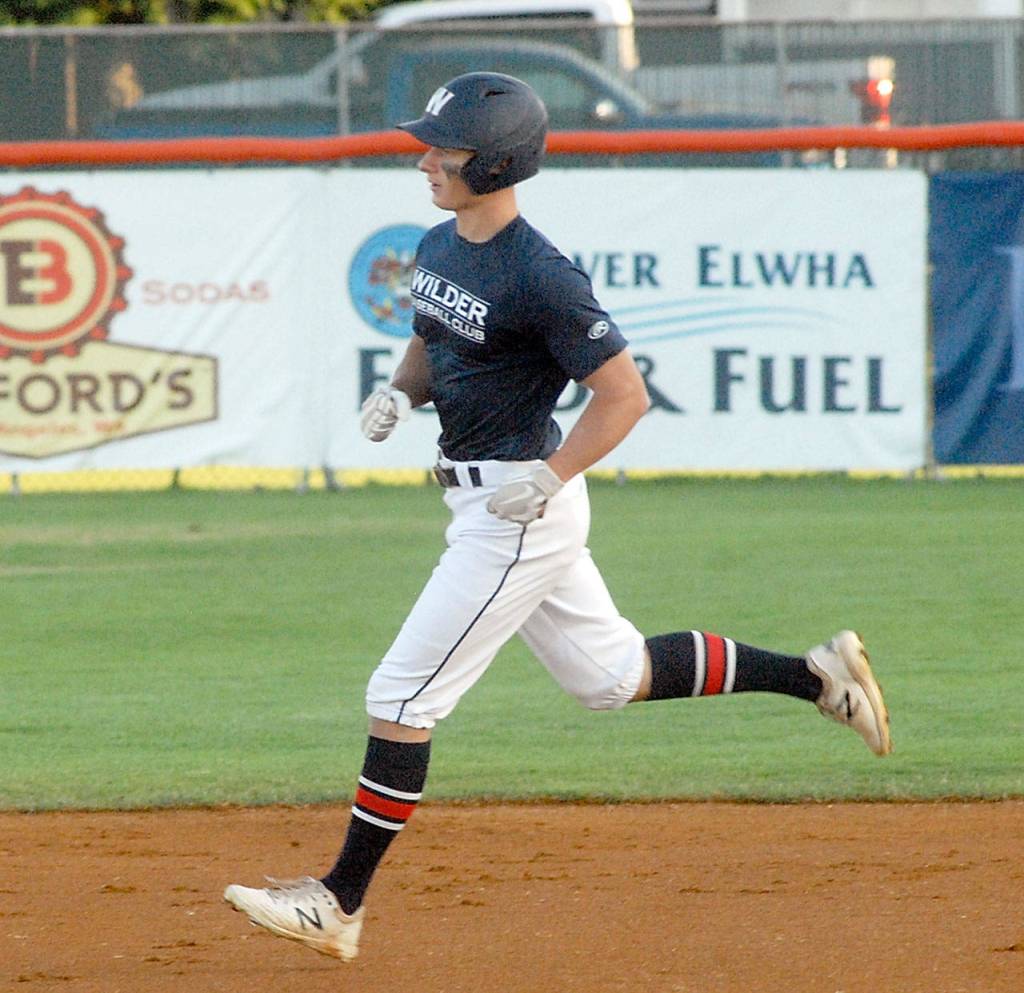 Keith Thorpe/Peninsula Daily News Wilders Jacob Felton rounds the bases after a first inning home run on Saturday against WBS Colts Red during the Dick Brown Memorial Firecracker Tourbnanmebt at Port Angeles Civic Field.