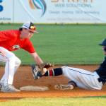 Keith Thorpe/Peninsula Daily News Wilders Logan Olson, left, makes it to second, beating the throw to WBS Colts Red shortstop Grady Smith on Saturday in Port Angeles.