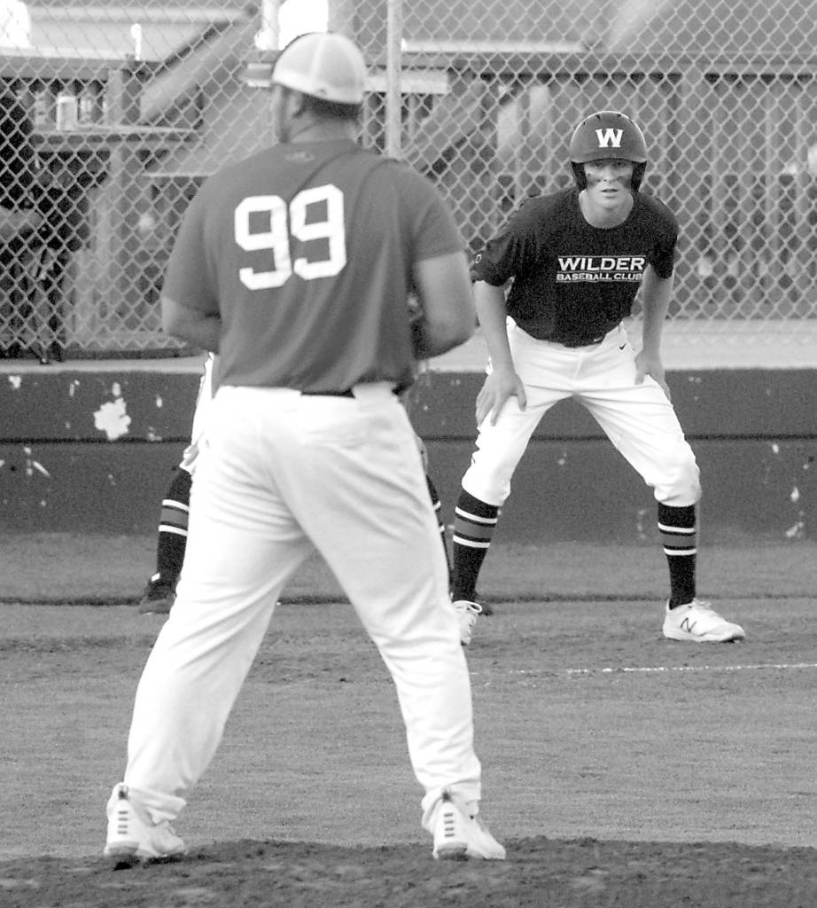 Keith Thorpe/Peninsula Daily News
Wilder's Wyatt Hall keeps a close watch on WBS Colts Red pitcher Jibran Murtaza as he takes his lead off of third in the second inning on Saturday in Port Angeles.