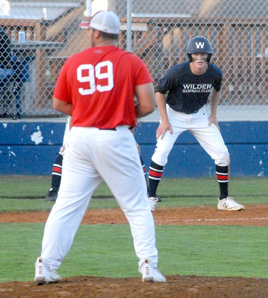 Keith Thorpe/Peninsula Daily News
Wilder's Wyatt Hall keeps a close watch on WBS Colts Red pitcher Jibran Murtaza as he takes his lead off of third in the second inning on Saturday in Port Angeles.