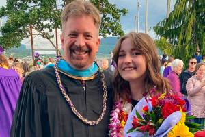 John Lorentzen visits with graduating senior Delaney Nucci after the Sequim High School 2021 graduation ceremony. (Photo courtesy of Nucci family)