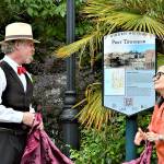 Historian Nathan Barnett of Olympic Peninsula Steam and Port Townsend Mayor Michelle Sandoval unveil a guide to the new Hidden History signs Thursday afternoon at Washington and Taylor streets. Fourteen interpretive signs, each revealing a facet of the citys past, are being posted around Uptown and downtown Port Townsend. (Diane Urbani de la Paz/Peninsula Daily News)