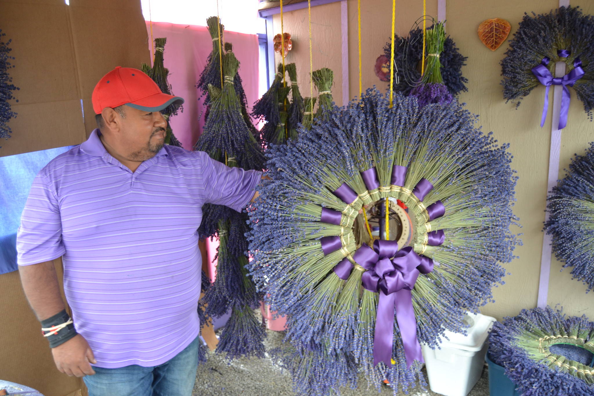 <strong>Matthew Nash</strong>/Olympic Peninsula News Group
Sergio Gonzalez stands with one of the wreaths he made for a customer from lavender in his field at Melis Lavender Farm. He hopes visitors will find his farm off Old Olympic Highway this summer as COVID-19 greatly impacted his sales in 2020.