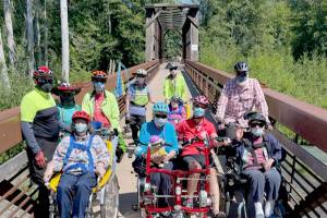 Members of the Sequim Wheelers break out all four of the nonprofits adaptive bikes for the first time on June 21, the first day of summer. (Photo by Tom Coonelly)