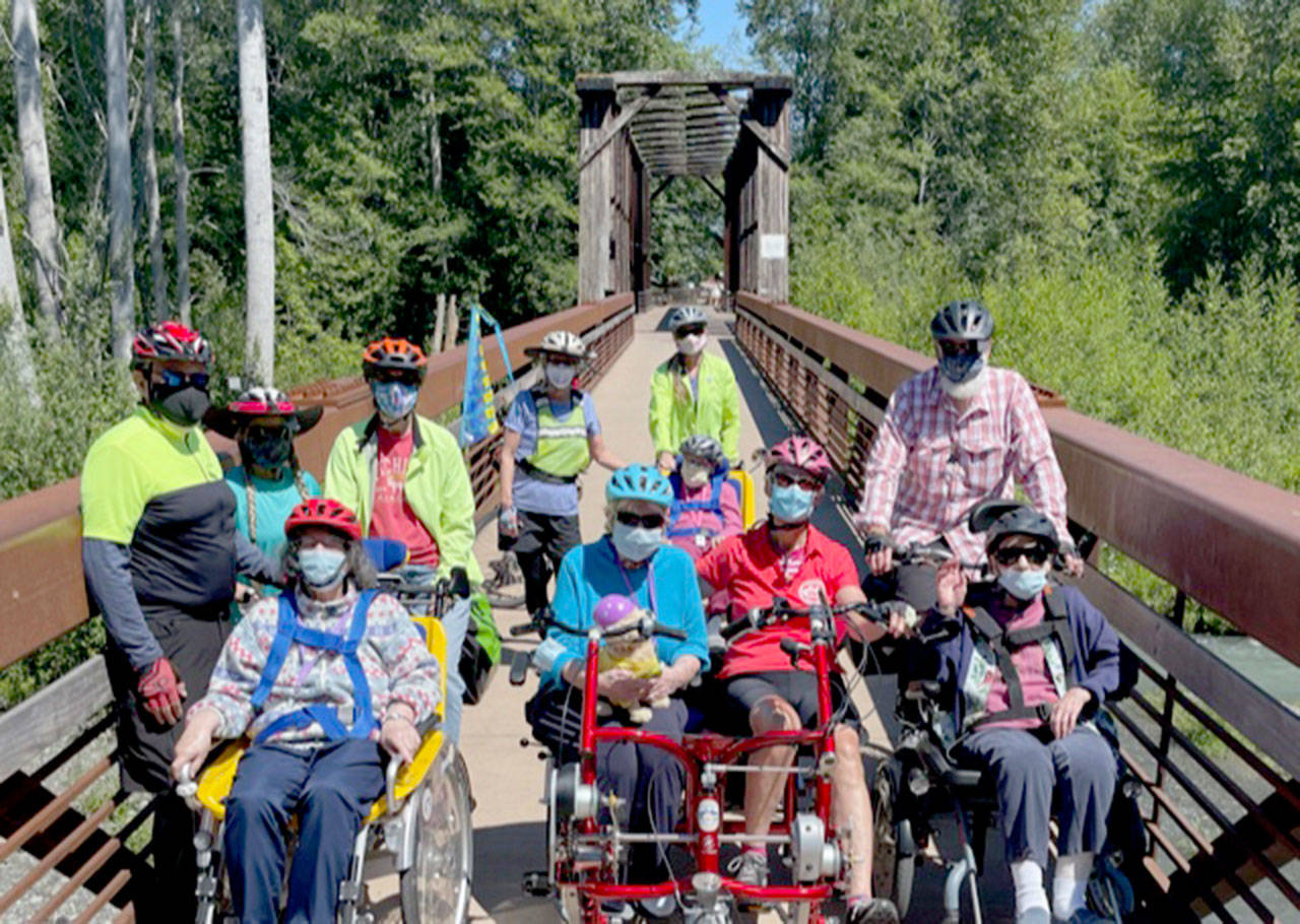 Members of the Sequim Wheelers break out all four of the nonprofits adaptive bikes for the first time on June 21, the first day of summer. (Photo by Tom Coonelly)