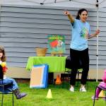 Rosaletta Curry, the Jefferson County Librarys early childhood program coordinator, begins story time by pointing out elements of the environment, such as trees. Ellie Long, 4, left, is among the listeners at story time outside the Port Townsend Library last Thursday. Story hours are offered free at libraries across the North Olympic Peninsula. For information, see NOLS.org and PTpubliclibrary.org. (Diane Urbani de la Paz/Peninsula Daily News)