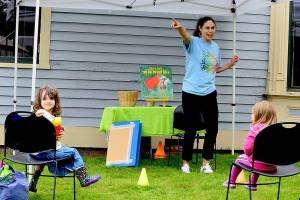 Rosaletta Curry, the Jefferson County Librarys early childhood program coordinator, begins story time by pointing out elements of the environment, such as trees. Ellie Long, 4, left, is among the listeners at story time outside the Port Townsend Library last Thursday. Story hours are offered free at libraries across the North Olympic Peninsula. For information, see NOLS.org and PTpubliclibrary.org. (Diane Urbani de la Paz/Peninsula Daily News)