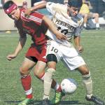 Southwestern Oregons Zachary Barker, left, battles with Peninsulas Erick Urzua in 2013 in Port Angeles. The NWAC-champion 2012 and 2013 Pirate mens and womens soccer teams will be inducted into the Pirates Hall of Fame along with longtime basketball scorekeeper Bill Peterson on Sept. 25. (Keith Thorpe/Peninsula Daily News)