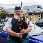 Erik Evans, the Parking Lot Piper, entertains people in downtown Sequim. (Emily Matthiessen/Olympic Peninsula News Group)