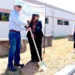 District 24 state legislature Rep. Steve Tharinger, left, and Cherish Cronmiller, Olympic Community Action Programs executive director, ceremoniously break ground for the newly dubbed 7th Haven project during a celebration with about 100 attendees on Thursday afternoon at the site of the future housing facility. (Zach Jablonski/Peninsula Daily News)