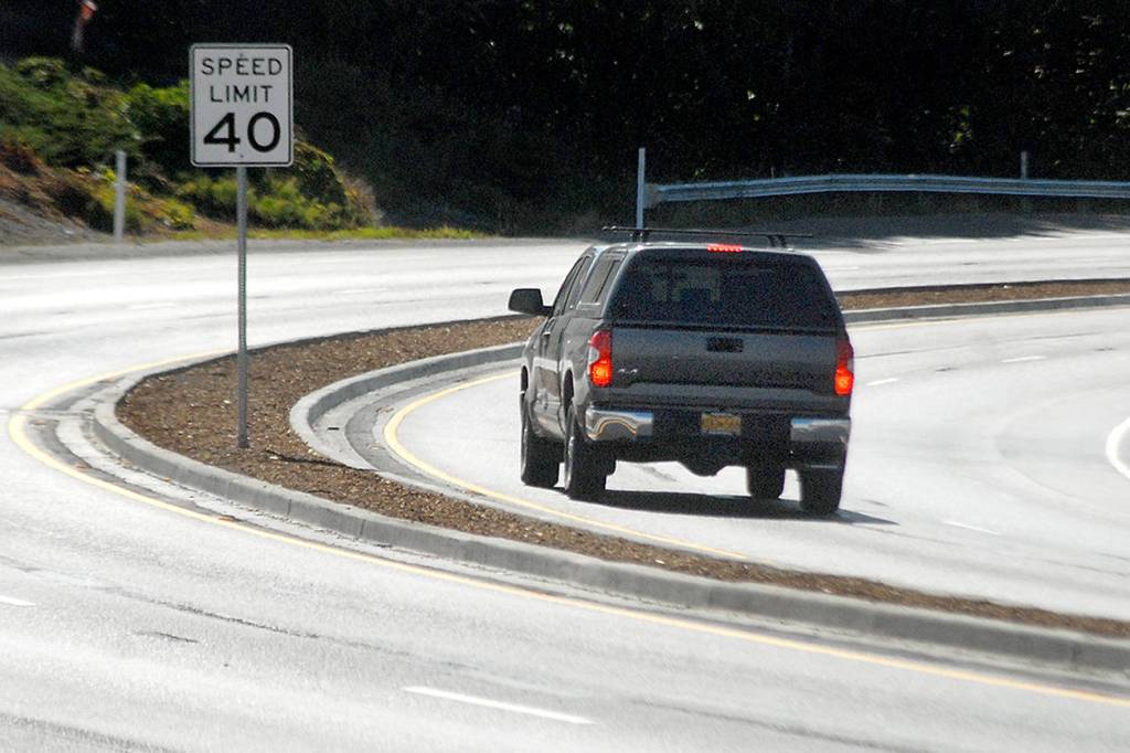 Keith Thorpe/Peninsula Daily News
A truck makes its way around a curve on a newly-divided section of U.S. Highway 101 on Saturday as the road descends into Morse Creek Valley east of Port Angeles.