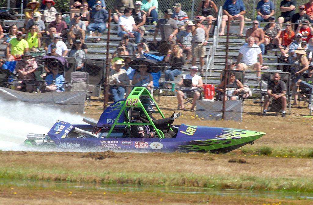 The Sequim-based Live Wire No. 2 sprint boat driven by Vaughan Trapp and navigated by Matt Denson roars past the Extreme Sports Park audience during Saturdays races in Port Angeles. (Keith Thorpe/Peninsula Daily News)