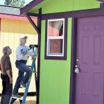 Cheryl Bentley, left, and Annalee McConnell are among the volunteers whove built, painted and furnished a village of tiny shelters off San Juan Avenue in Port Townsend. The Community Build site will host an open house Saturday afternoon. (Diane Urbani de la Paz/Peninsula Daily News)