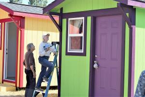Cheryl Bentley, left, and Annalee McConnell are among the volunteers whove built, painted and furnished a village of tiny shelters off San Juan Avenue in Port Townsend. The Community Build site will host an open house Saturday afternoon. (Diane Urbani de la Paz/Peninsula Daily News)