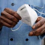 In this March 5 photo, a restaurant worker holds his face mask in Biloxi, Miss. The nations top health agency backpedaled on its masking guidelines and recommend that even vaccinated people wear masks indoors in parts of the U.S. where the coronavirus is surging. (Rogelio V. Solis/The Associated Press)