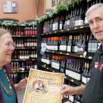 Douglas Everett, Sequim Grocery Outlet owner, receives event fliers from Carol Willis.