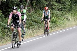 A large group of Ride the Hurricane bicyclists approach the Heart O the Hills near the beginning of the 17-mile trek up to 5,242 feet. About 800 riders participated in the event on Sunday with a round-trip ride to the top of Hurricane Ridge and back to Port Angeles. (Dave Logan/for Peninsula Daily News)