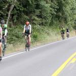 A large group of Ride the Hurricane bicyclists approach the Heart O the Hills near the beginning of the 17-mile trek up to 5,242 feet. About 800 riders participated in the event on Sunday with a round-trip ride to the top of Hurricane Ridge and back to Port Angeles. (Dave Logan/for Peninsula Daily News)