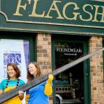 Holding a piece of baleen from a bowhead whale, Port Townsend Marine Science Center exhibit and outreach specialist Mandi Johnson, left, and aquarium specialist Marley Loomis stand before the centers newly acquired Flagship Landing building in downtown Port Townsend. (Diane Urbani de la Paz/Peninsula Daily News)
