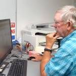 Clallam County election worker Daniel Cain of Sequim consults a database of signatures to verify ballots on Tuesday at the courthouse in Port Angeles. Results of the primary election were posted online Tuesday night, and they will be explored in depth in Thursdays print edition. (Keith Thorpe/Peninsula Daily News)
