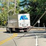 A semi-truck got caught in downed power lines along U.S. Highway 101 at milepost 302 that are believed to have been pulled down by an overheight vehicle Wednesday afternoon.  (Photo Courtesy of Brinnon Fire Department)