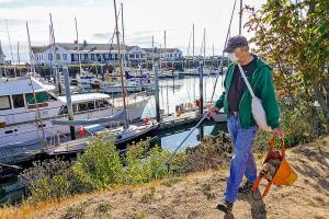 Gary Engbrecht has a hobby like no other. Everyone needs a hobby, he says. Mine is picking up trash strewn around the town. I think Ive emptied this bag about five times already and it is just 9 a.m. During the weekend, Engbrecht, who is the production manager for the Port Townsend Film Festival, concentrated his efforts at the Point Hudson Marina in Port Townsend. (Steve Mullensky/for Peninsula Daily News)