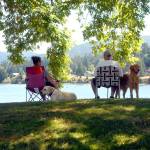 Laurie and Ford Rathbun of Bonney Lake, along with dogs Chevy and Jack, take in the view of Sequim Bay from John Wayne Marina near Sequim. The couple and their pets were staying in a nearby RV park and decided to spend part of their day lounging by the bay. (Keith Thorpe/Peninsula Daily News)