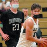 Port Angeles' Chase Cobb, front, makes his way past Klahowya's Robbie Slater in a game last March at Port Angeles High School. Masks will not be required for vaccinated athletes playing high-risk indoor sports such as basketball and wrestling this winter. Non-vaccinated athletes must mask and pass twice weekly COVID screening. (Keith Thorpe/Peninsula Daily News)