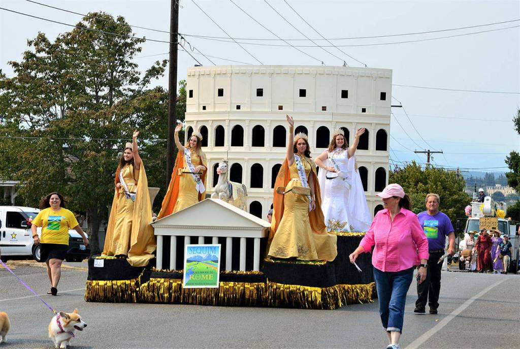 The Sequim Irrigation Festival float, whose theme is A Place for You to Rome, rolled through Port Townsend in the 85th annual Rhododendron Festival Grand Parade on Saturday. The royalty, from left, are Princesses Allie Gale, Zoee Kuperus and Sydney VanProyen and Queen Hannah Hampton. (Diane Urbani de la Paz/Peninsula Daily News)