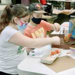 Jasmine Paul, 9, left, and John Hall, 10, put together a habitat diorama in which animals might live in nature after gathering materials in Websters Woods at Port Angeles Fine Art Center. (Dave Logan/For Peninsula Daily News)