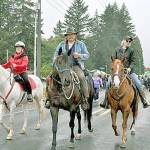 Back Country Horsemen of Washington members Linda Morin, left, Ray and Rochelle Sutherland had a grand time leading the equine entries in the parade as a part of the Joyce Daze Wild Blackberry Festival. Members from three Olympic Peninsula chapters participated. (Photo by Denise Hupfer/Peninsula chapter Back Country Horsemen of Washington)