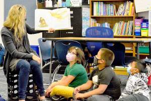 Chimacum Elementary summer school teacher Michelle Moseley reads What Do You Do with a Chance? to her students Tuesday morning. (Diane Urbani de la Paz/Peninsula Daily News)