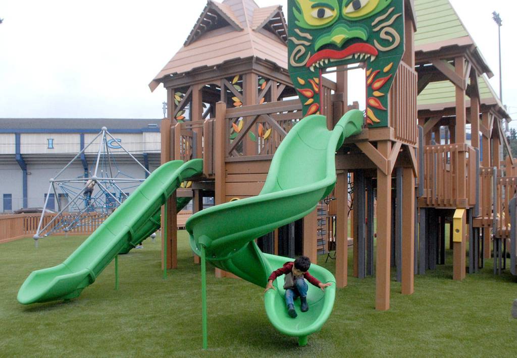 Four-year-old Jett Johnson of Port Angeles makes his way down a slide at the Dream Playground on Friday in Port Angeles. (Keith Thorpe/Peninsula Daily News)