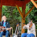John Greyhound Maxwell, left, and Jon Parry dish up blues and swing Saturday afternoon outside the Laurel B. Johnson Community Center in Coyle. Their show was likely to be the last of the seasons Concerts in the Woods series. (Diane Urbani de la Paz/Peninsula Daily News)