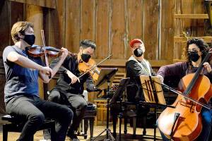 The barn at Trillium Woods Farm near Quilcene is the setting for free chamber concerts this summer, including last Sundays performance by, from left, James Garlick, Richard ONeill, Jeremy Denk and Ani Aznavoorian. This weekend will bring the final Concerts in the Barn at 2 p.m. Saturday and Sunday. Patrons who sit inside the barn must show proof of vaccination. (Diane Urbani de la Paz/Peninsula Daily News)