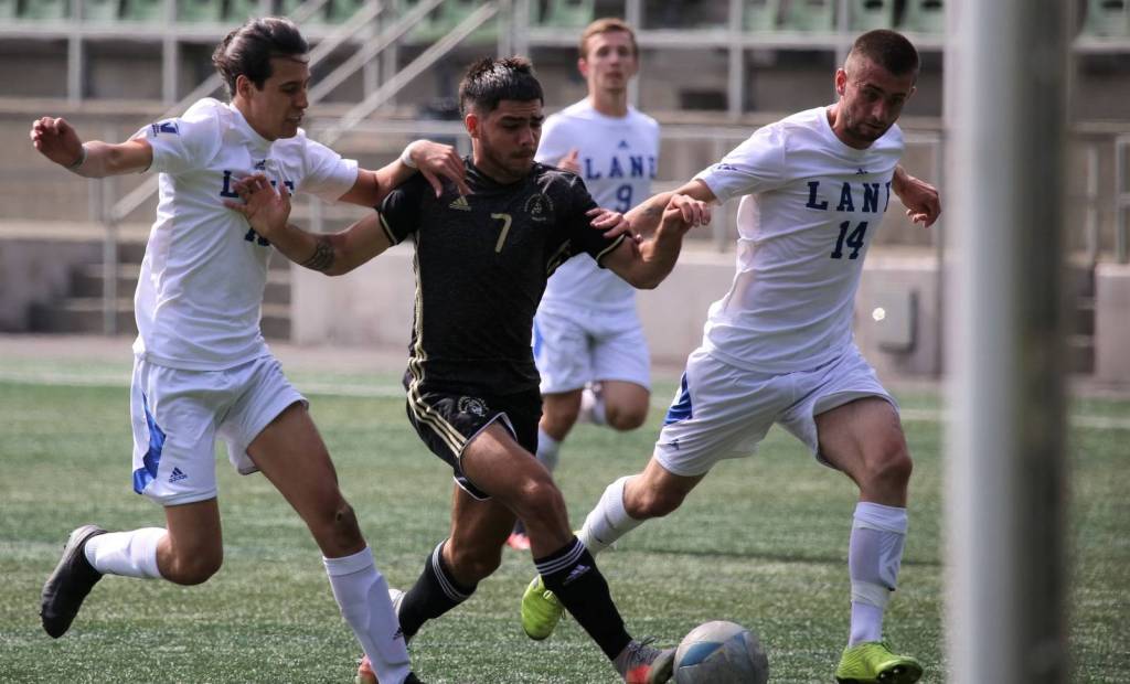 Peninsulas Jonathon De Motta, middle, prepares to shoot while being covered by a pair of Lane defenders during the Pirates season-opening 2-0 win Wednesday at Starfire Sports Complex in Tukwila. (Rick Ross/Peninsula College Athletics)