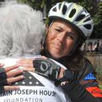 Keith Thorpe/Peninsula Daily News
Special education kindergarten teacher Amy DelaBarre of Port Angeles gives an emotional hug to Betsy Schulz, founder of the Captain Joseph House Foundation in Port Angeles, after DelaBarre completed the bicycle portion of "Run for Joe," a solo triathelion on Saturday to raise funds in support of Gold Star families who have lost loved ones in military action. The Captain Joseph House, a former bed-and-breakfast which was converted to give respite to military families, is named for Schultz' son, Joseph Schultz, who was killed in action in Afghanistan on May 29, 2011.