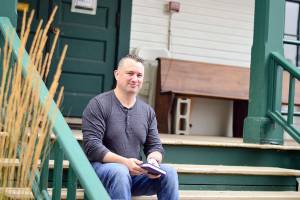 Joe Gillard of Quilcene, pictured on the steps of the Centrum building where he works, is author of The Little Book of Lost Words. (Diane Urbani de la Paz/Peninsula Daily News)